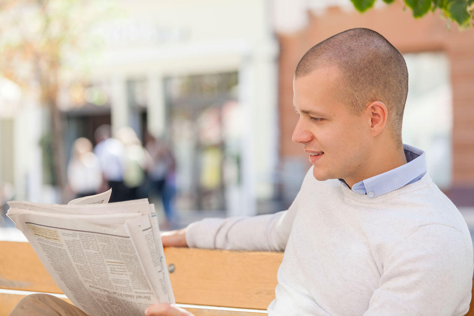Young adult reading newspaper